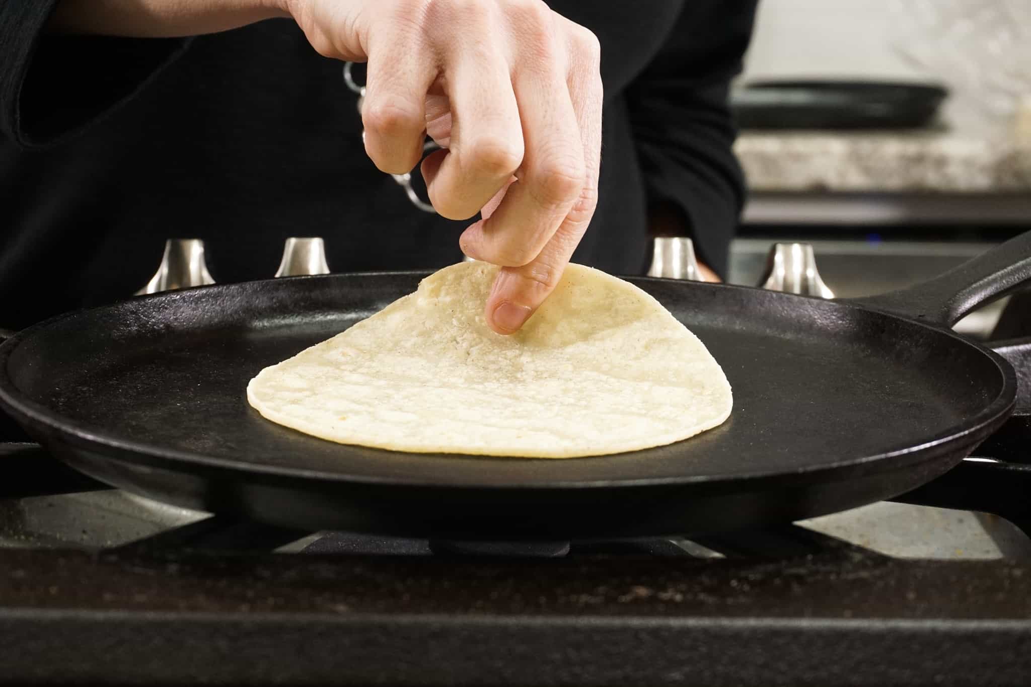 heating up corn tortillas on the skillet