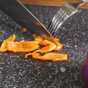 slicing habanero peppers to make salsa de habanero