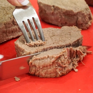 cutting the eye of round that was cooked in the instant pot before mincing it