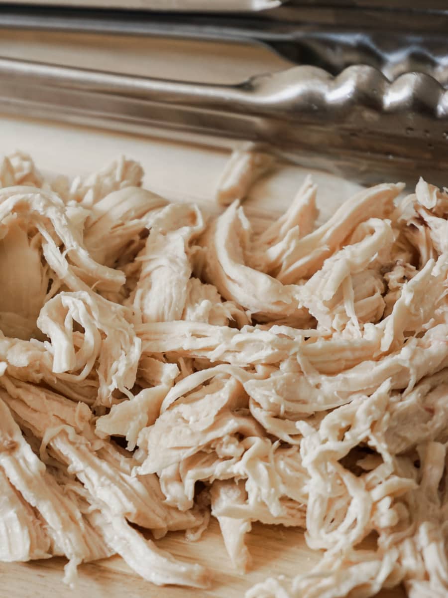 shredded chicken breast on a wooden board