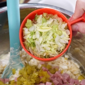 adding lettuce to this easy macaroni salad recipe