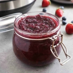 a glass jar filled with berry jam