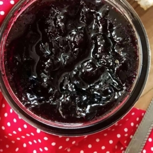 overhead shot of blueberry jam in a large glass bowl