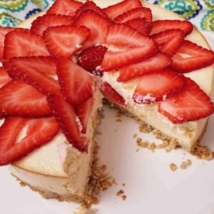 cheesecake decorated with slices of strawberries