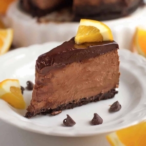 a chocolate orange cheesecake topped with orange slices