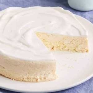 a partially sliced keto ricotta lemon cheesecake