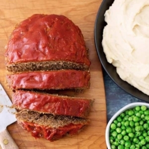 overhead shot of sliced meatloaf  on a wooden board