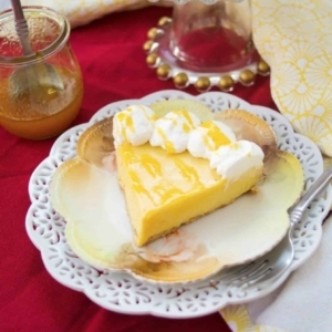 a large slice of passion fruit pie decorated with whipped cream on a plate