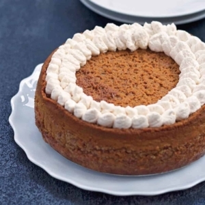 a large plate of pumpkin pie decorated with whipped cream