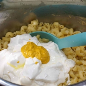 adding mayo, sour cream, mustard and pickle juice for making creamy macaroni salad in the instant pot