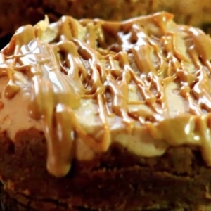 a peanut butter cheesecake dripping with soft peanut butter