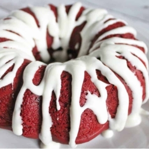 close up of a glazed red velvet bundt cake