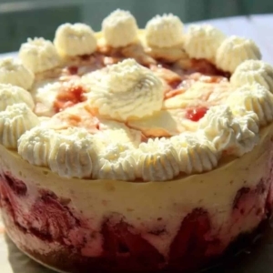 side view of a decorated strawberry lime cheesecake