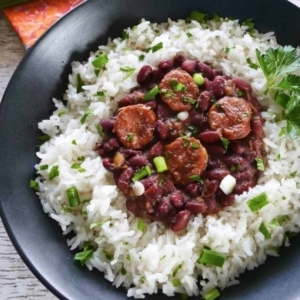 authentic red beans and rice on a plate garnished with bits of cilantro and green onion