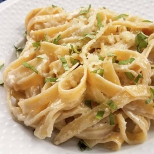 close up of a plate of alfredo pasta