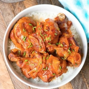 chicken legs in a bowl filled with rice