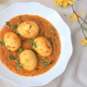 top view of egg curry in a bowl garnished with cilantro