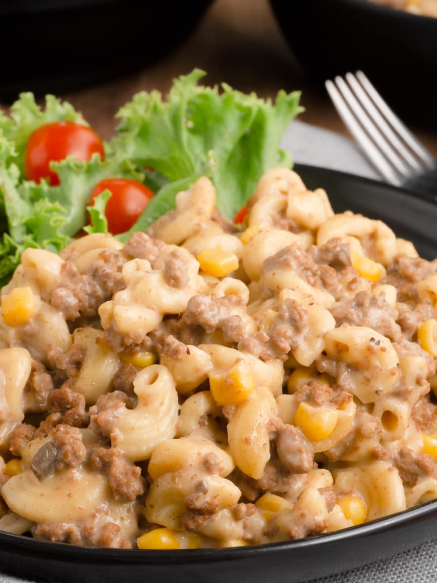 a bowl of ground beef macaroni topped with parmesan