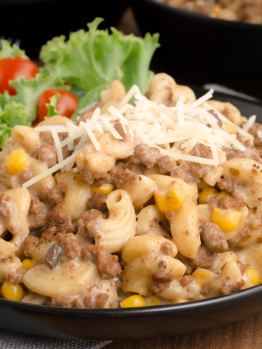 two servings of macaroni and ground beef in a bowl and plate