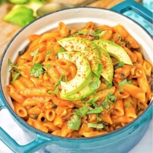 vegetarian fajita pasta topped with avocado slices and pieces of cilantro