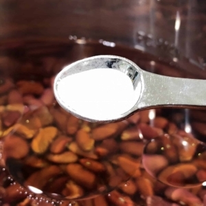 adding baking soda to the beans