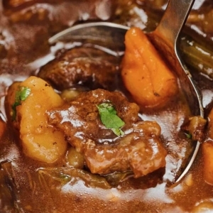 close up of beef stew garnished lightly with cilantro