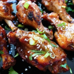 teriyaki wings garnished with sesame seeds, cilantro, and green onion