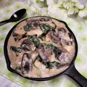 a large serving of creamy parmesan garlic mushroom chicken in a bowl