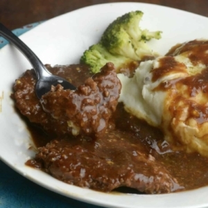 cubed steak and gravy on a dinner plate