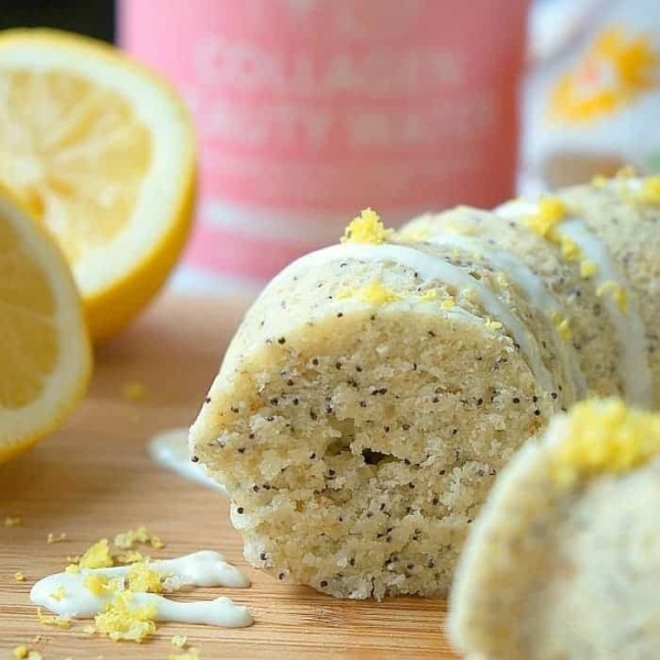 a piece of a lemon poppy seed cake near slices of lemon