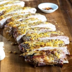 a large line of ribs on a wooden board