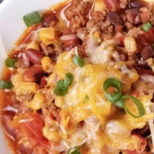 close up of football chili garnished with scallions