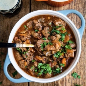 guinness beef stew in a bowl garnished with cilantro