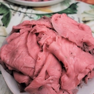 a pile of roast beef on a plate