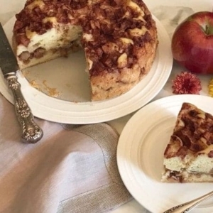 a cut into apple cake on a large plate