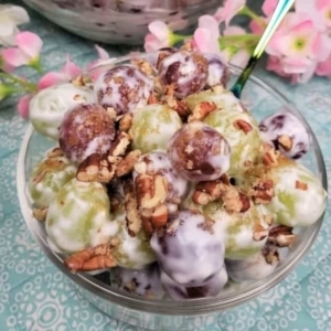 creamy grapes salad in a large glass serving bowl