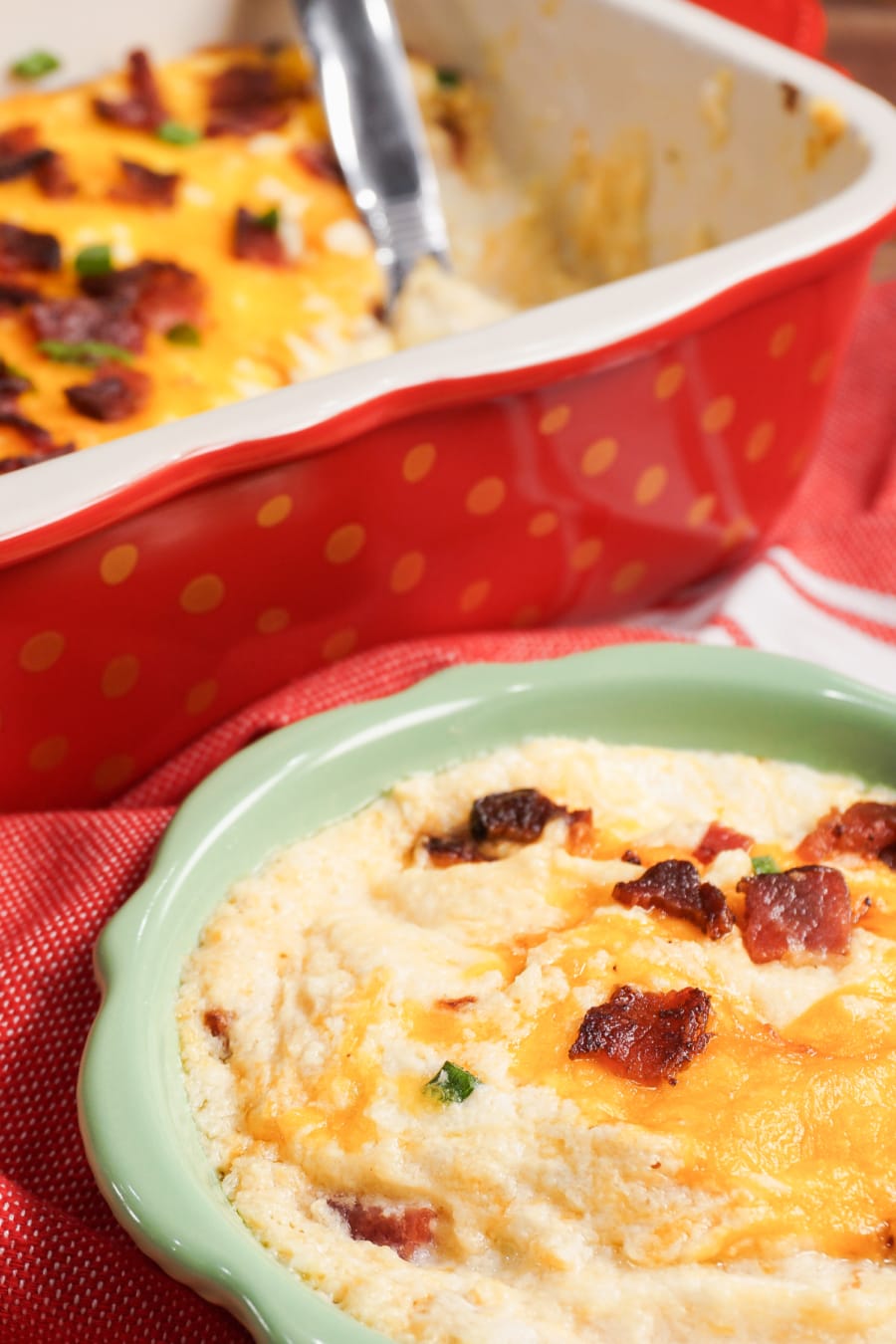 a plate of cauliflower casserole near a serving bowl of cauliflower casserole