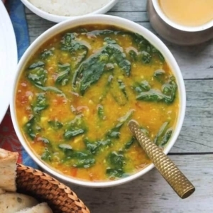 overhead shot of a bowl filled up with spinach dal with rice