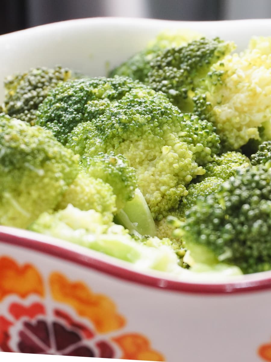 close up of a large bowl with lemon butter broccoli