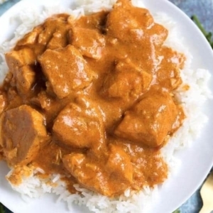 overhead shot of butter chicken on a bed of rice