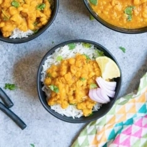 three bowls of chana dal garnished with cilantro