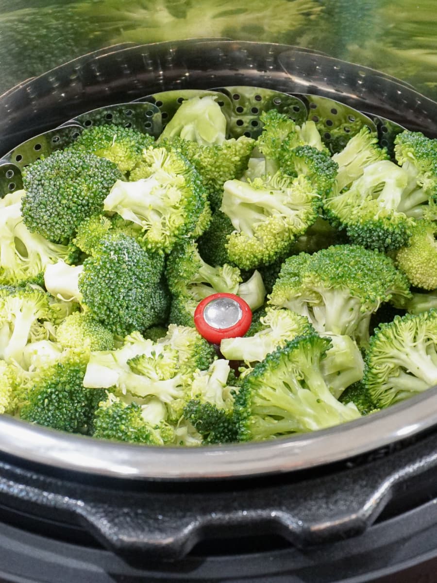 an instant pot filled with steaming broccoli