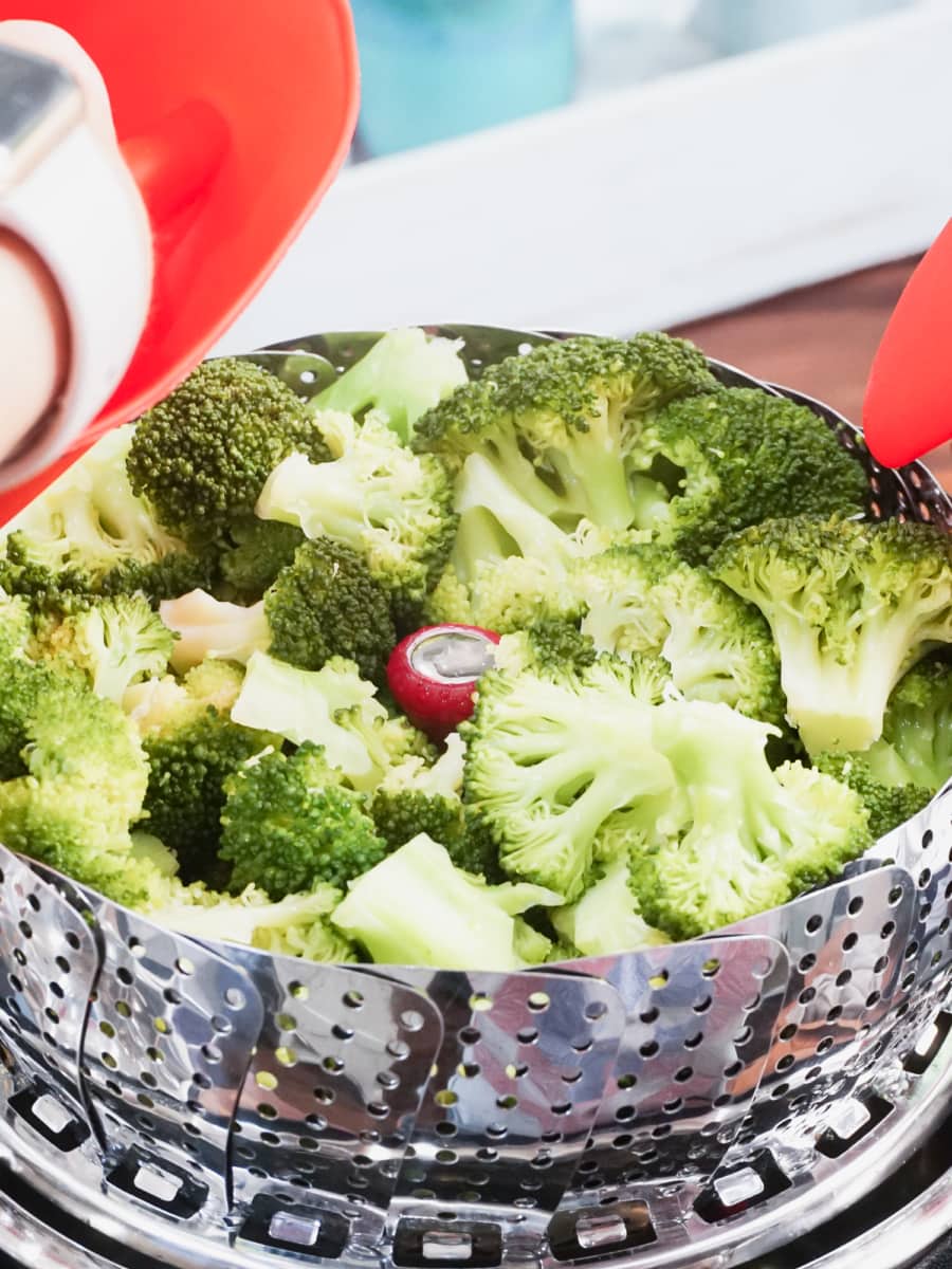 steamer basket filled with steamed broccoli