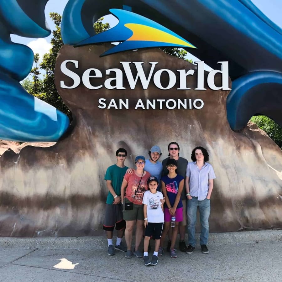 the family posing at the entrance of sea world at san antonio