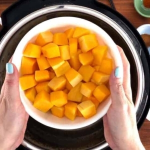 a bowl of butternut squash over the instant pot