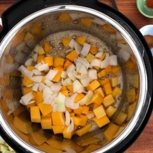 adding butternut squash and onion to the instant pot