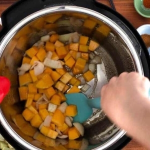 mixing butternut squash and onion in the instant pot