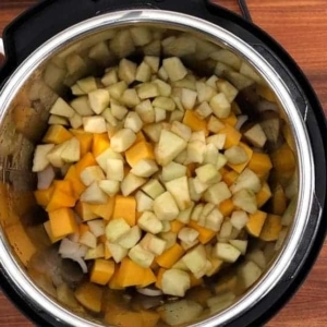 mixing together apples and butternut squash in the instant pot