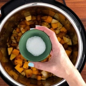 adding salt to butternut squash soup in the instant pot