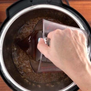 adding beef stock to the instant pot